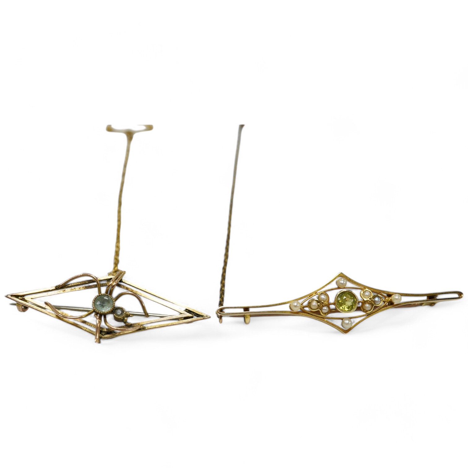 An Edwardian 15ct, peridot and seed pearl set bat brooch, 50mm, together with a similar 9ct and gem set bug brooch. Condition - fair to good